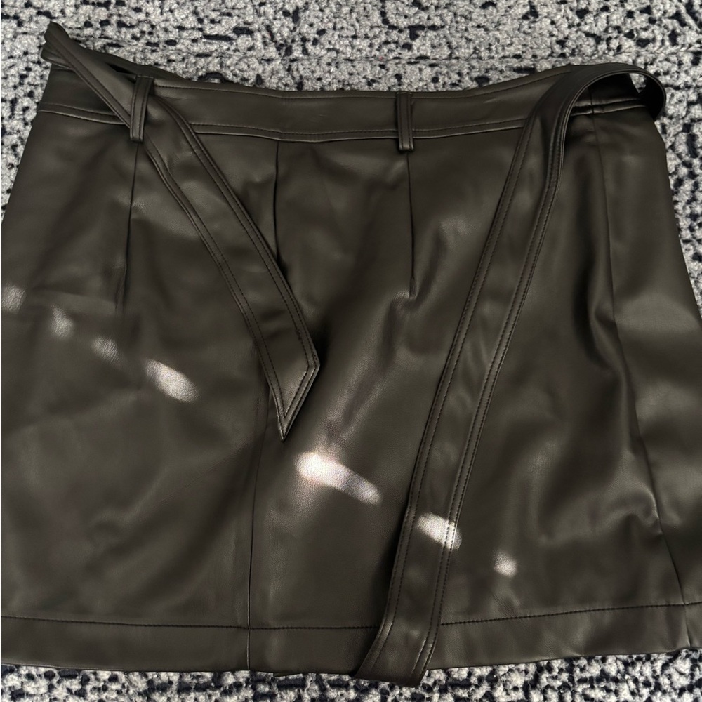 tags still on black leather skirt